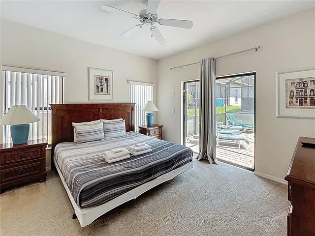 a spacious bedroom with a bed and a chandelier