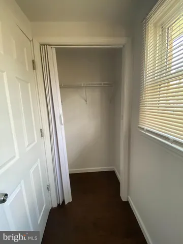 an empty room with a ceiling fan and a window