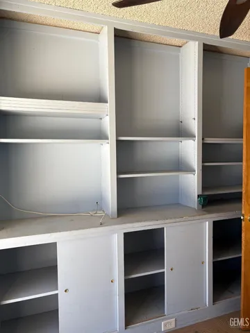 an empty room with a empty space and windows