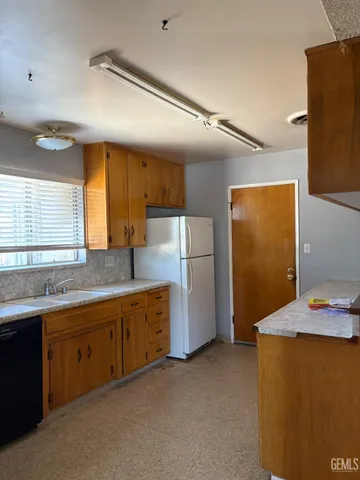 a kitchen with refrigerator and window