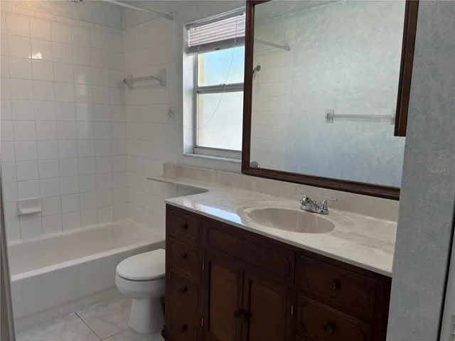a bathroom with a sink toilet a vanity and bathtub