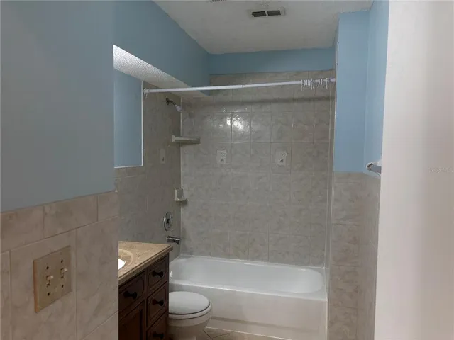 a bathroom with a shower and a toilet
