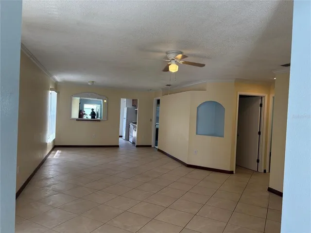 an empty room with windows and mirror