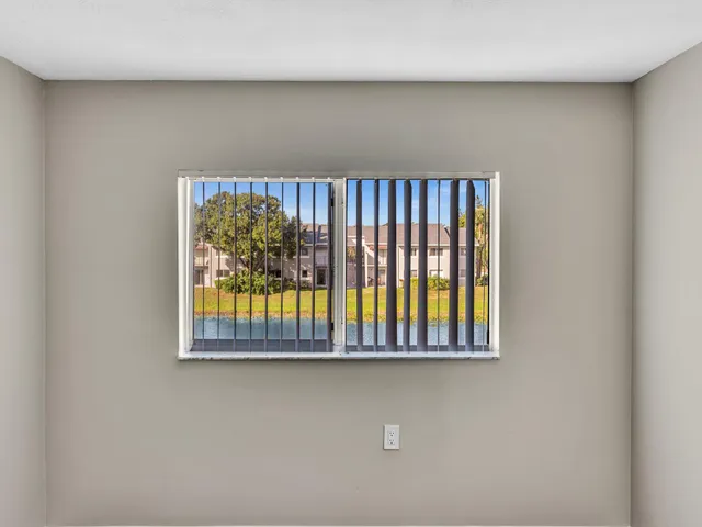 a view of a room with wooden floor staircase and a hallway