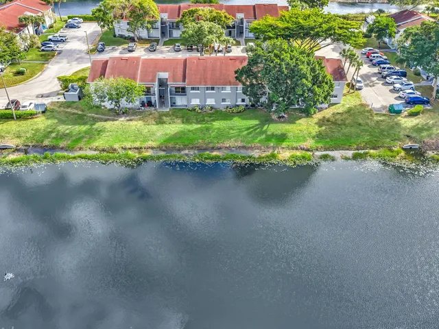 an aerial view of residential building and lake