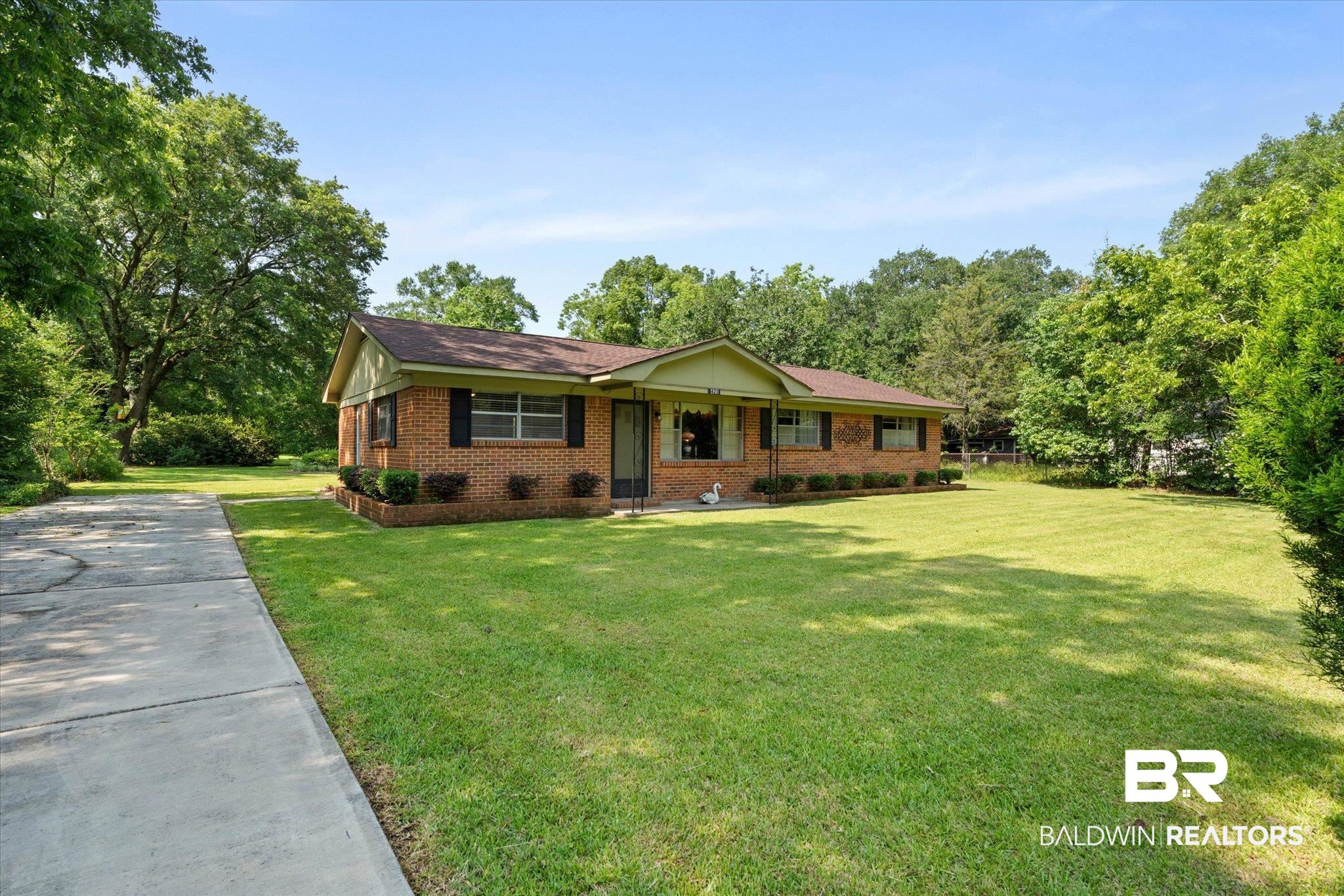 423 First Avenue Saraland, AL 36571 - Photo 19 of 20 Single story home with a front yard, brick siding, and driveway