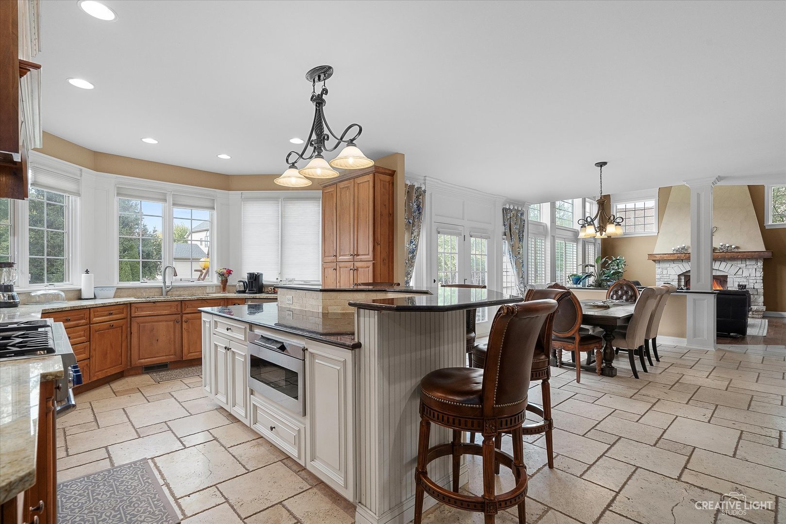 4520 Corktree Road Naperville, IL 60564 - Photo 3 of 50 a kitchen with stainless steel appliances granite countertop a table chairs sink and cabinets