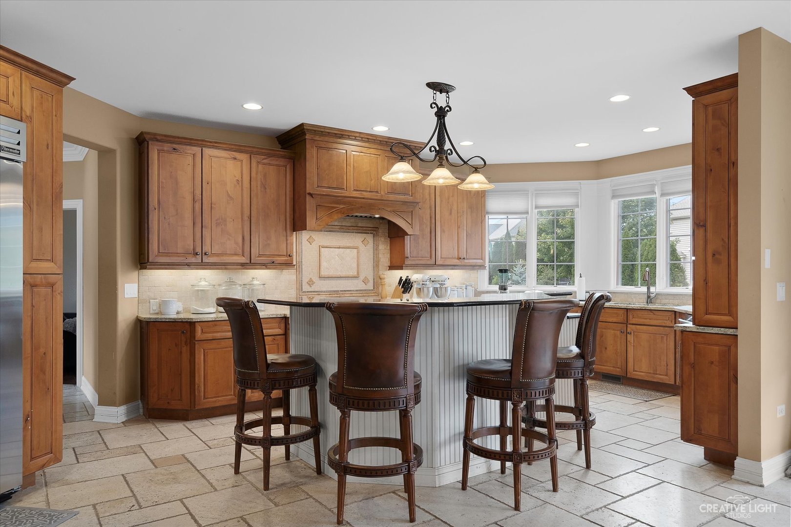 4520 Corktree Road Naperville, IL 60564 - Photo 6 of 50 a kitchen with stainless steel appliances granite countertop wooden cabinets a dining table and chairs