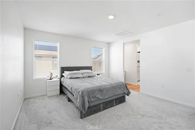 a bedroom with a bed and window