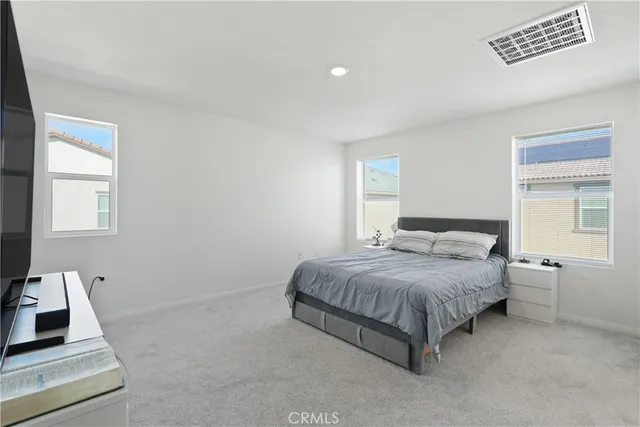 a bedroom with a bed and window