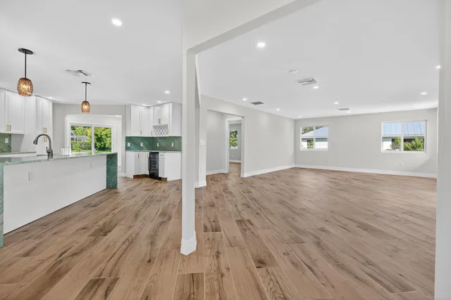 a view of a kitchen with wooden floor and a sink