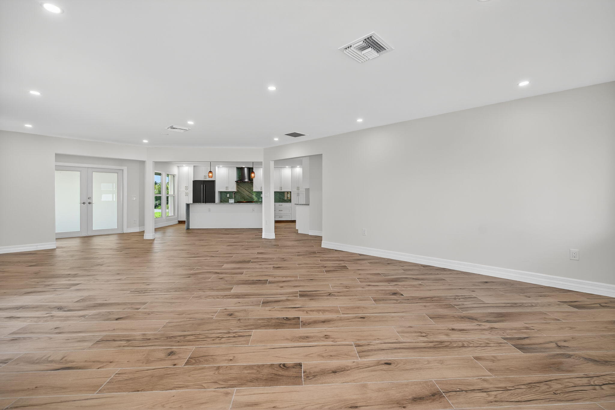 5273 Southeast Tall Pines Way Stuart, FL 34997 - Photo 16 of 62 a view of empty room with wooden floor