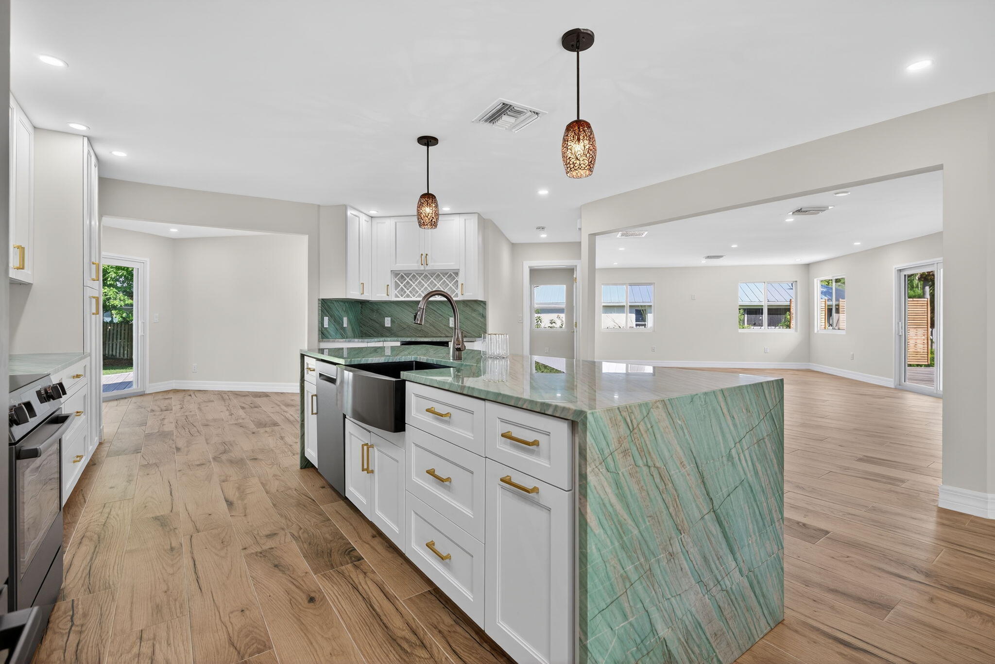 5273 Southeast Tall Pines Way Stuart, FL 34997 - Photo 24 of 62 a kitchen with stainless steel appliances granite countertop a sink a stove and a wooden floors