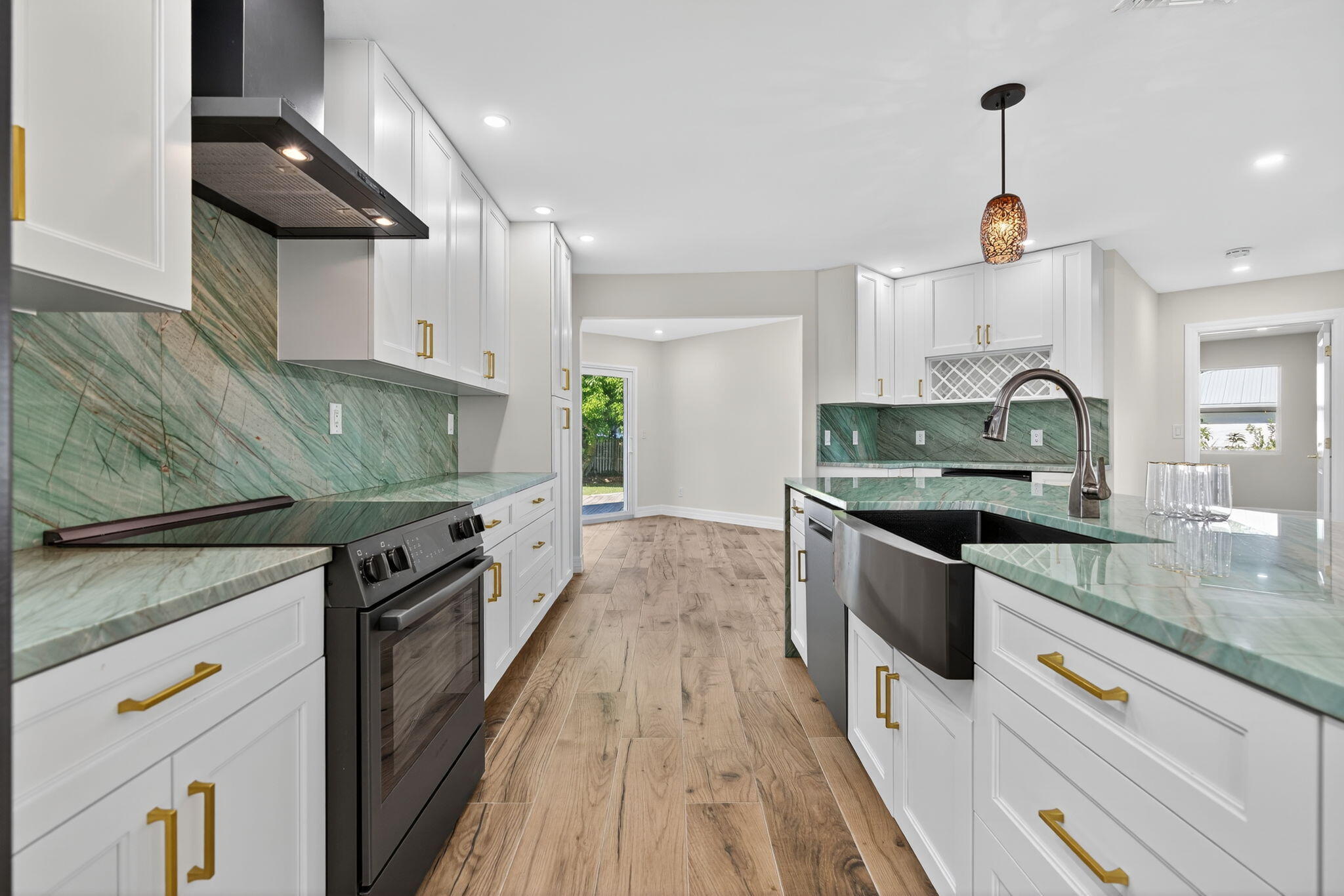 5273 Southeast Tall Pines Way Stuart, FL 34997 - Photo 25 of 62 a kitchen with stainless steel appliances granite countertop a sink a stove and a wooden floors