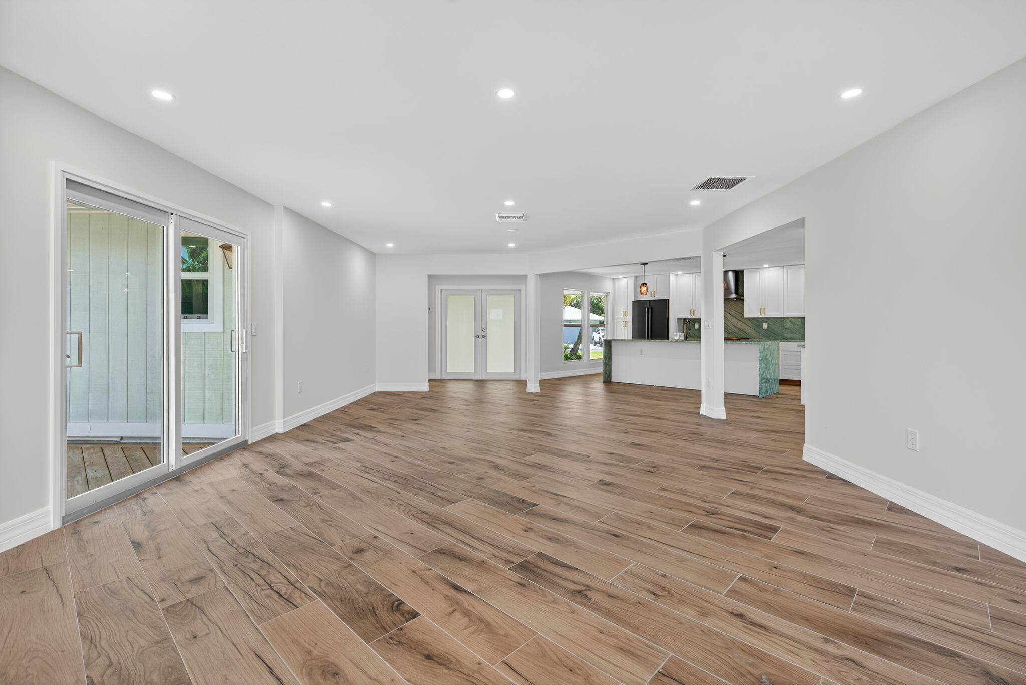 5273 Southeast Tall Pines Way Stuart, FL 34997 - Photo 27 of 62 a view of an empty room with wooden floor and a window