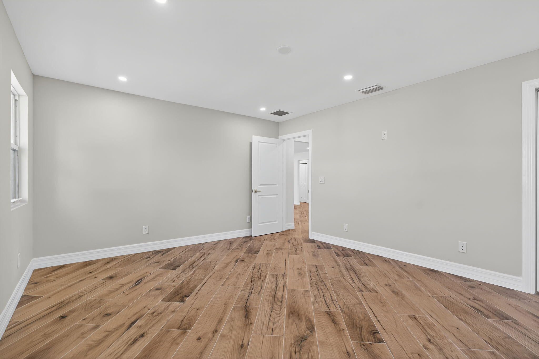 5273 Southeast Tall Pines Way Stuart, FL 34997 - Photo 30 of 62 a view of an empty room with wooden floor