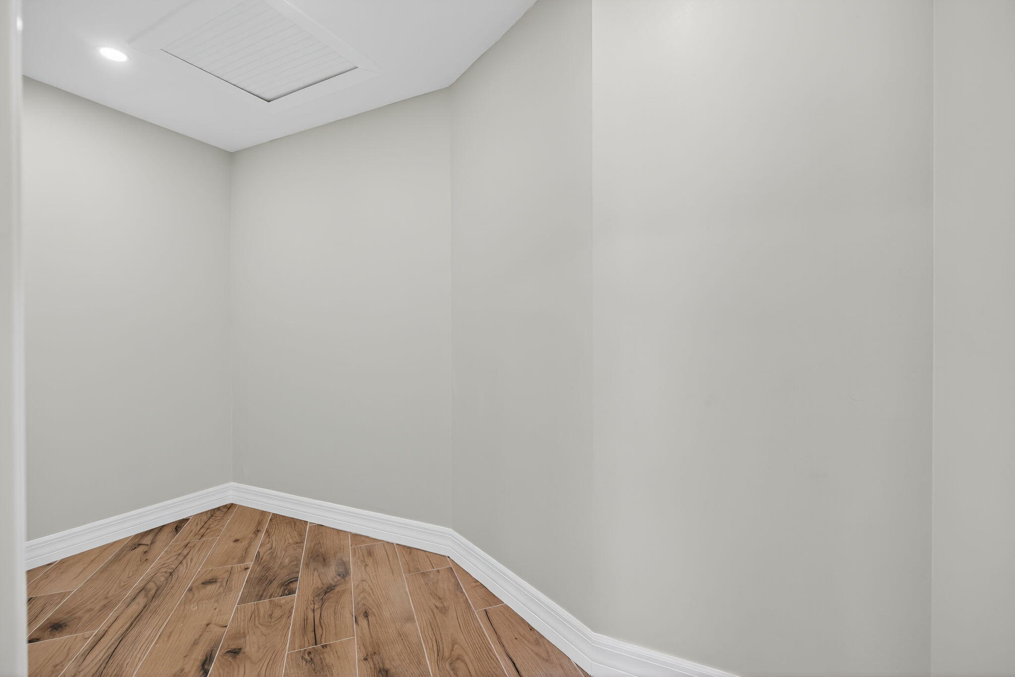 5273 Southeast Tall Pines Way Stuart, FL 34997 - Photo 32 of 62 a view of an empty room with wooden floor