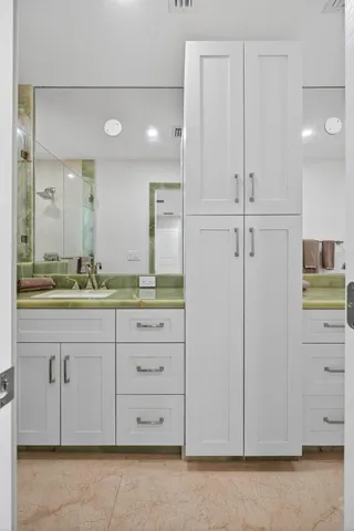 an empty room with wooden floor and a potted plant