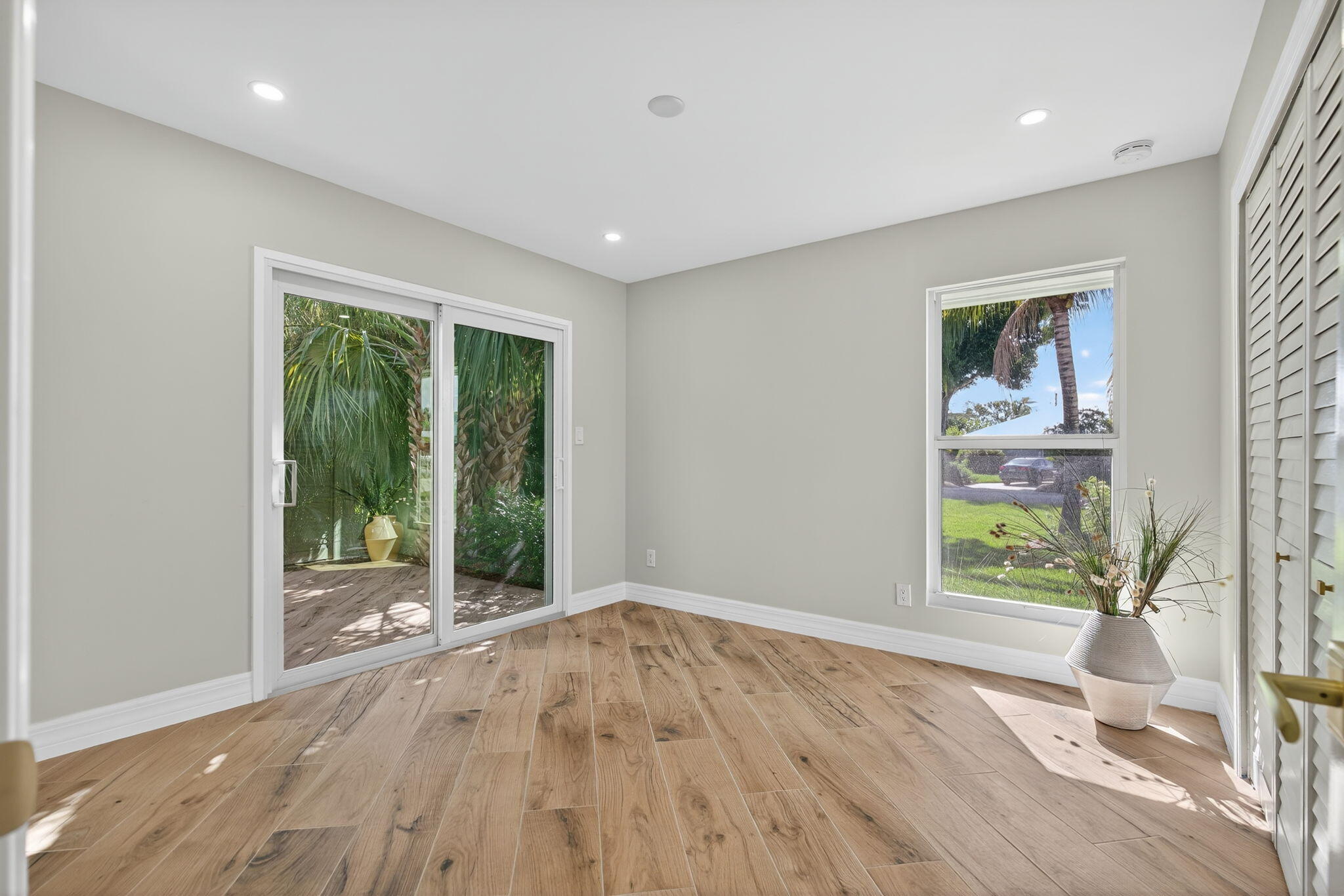 5273 Southeast Tall Pines Way Stuart, FL 34997 - Photo 36 of 62 a view of an empty room with wooden floor and a window