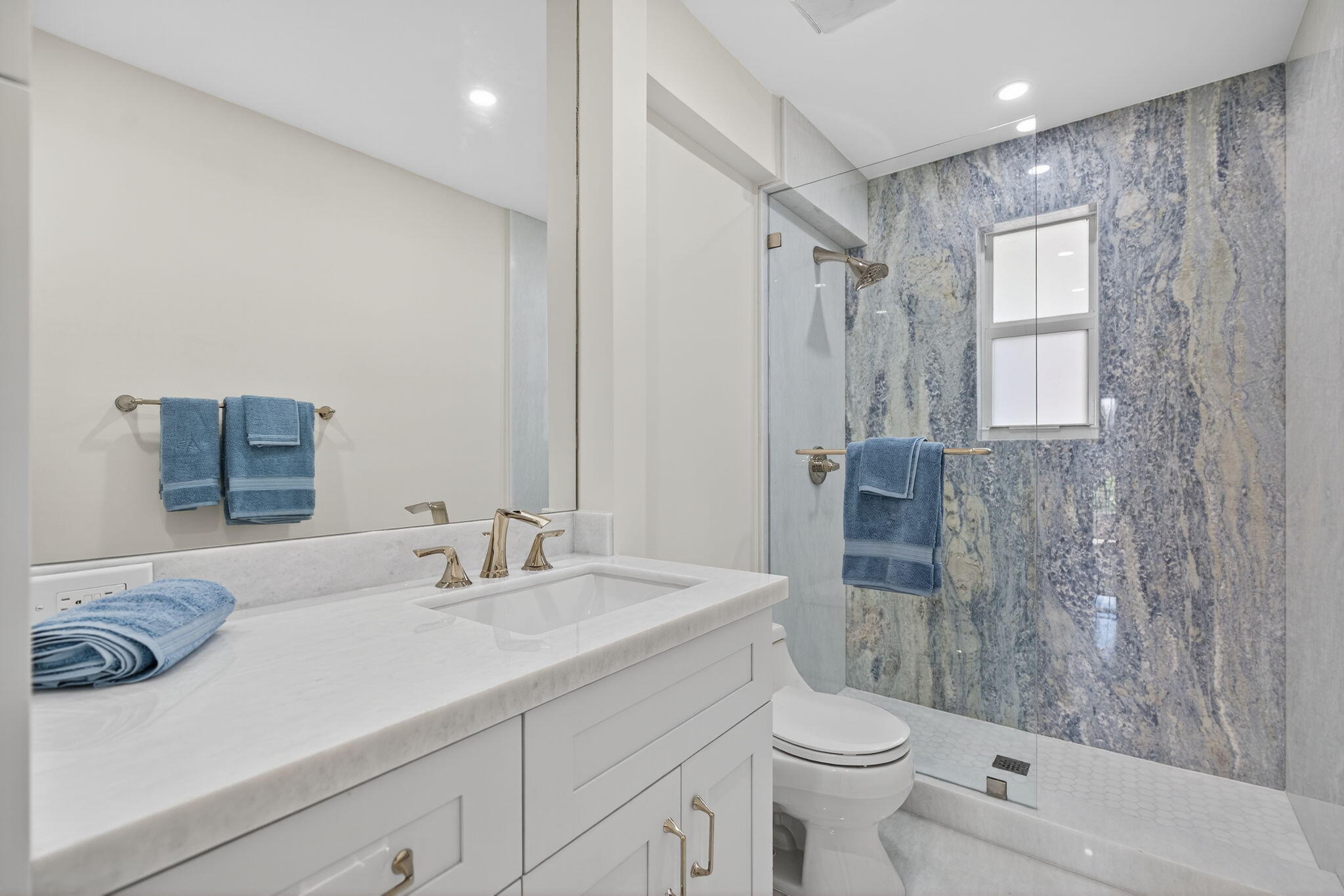 5273 Southeast Tall Pines Way Stuart, FL 34997 - Photo 38 of 62 a bathroom with a sink a toilet and shower