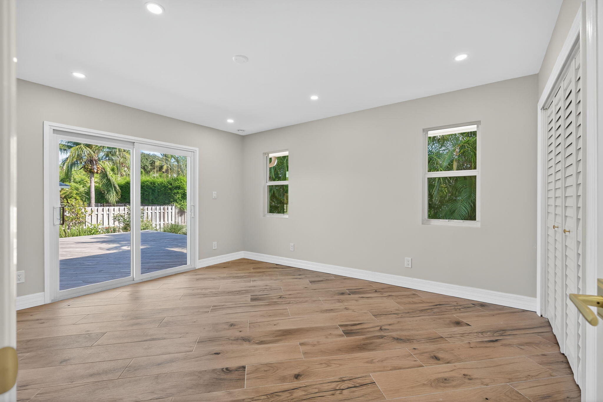 5273 Southeast Tall Pines Way Stuart, FL 34997 - Photo 39 of 62 a view of an empty room with wooden floor and a window