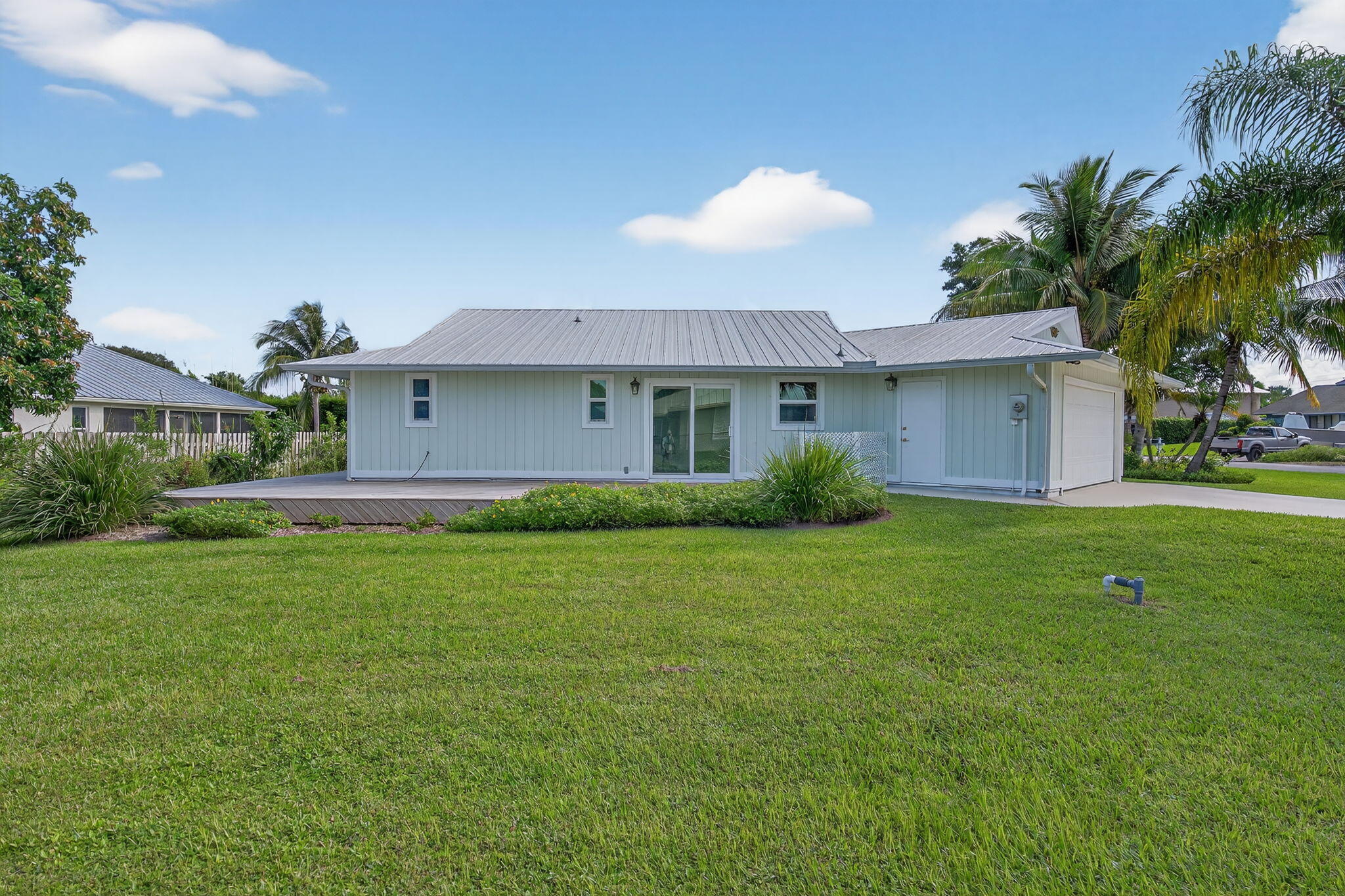 5273 Southeast Tall Pines Way Stuart, FL 34997 - Photo 4 of 62 a front view of house with yard and green space