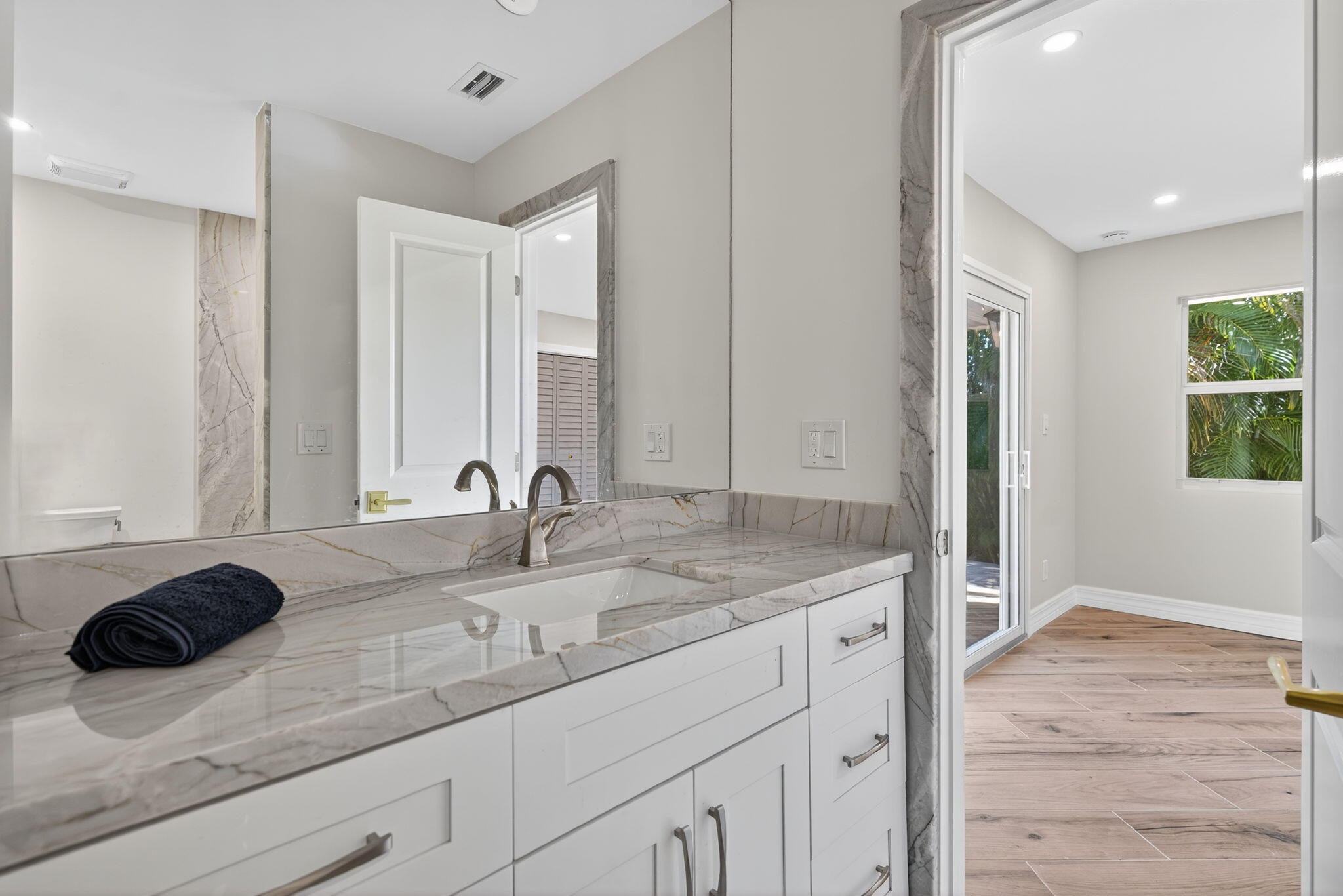 5273 Southeast Tall Pines Way Stuart, FL 34997 - Photo 45 of 62 a bathroom with a sink and a mirror