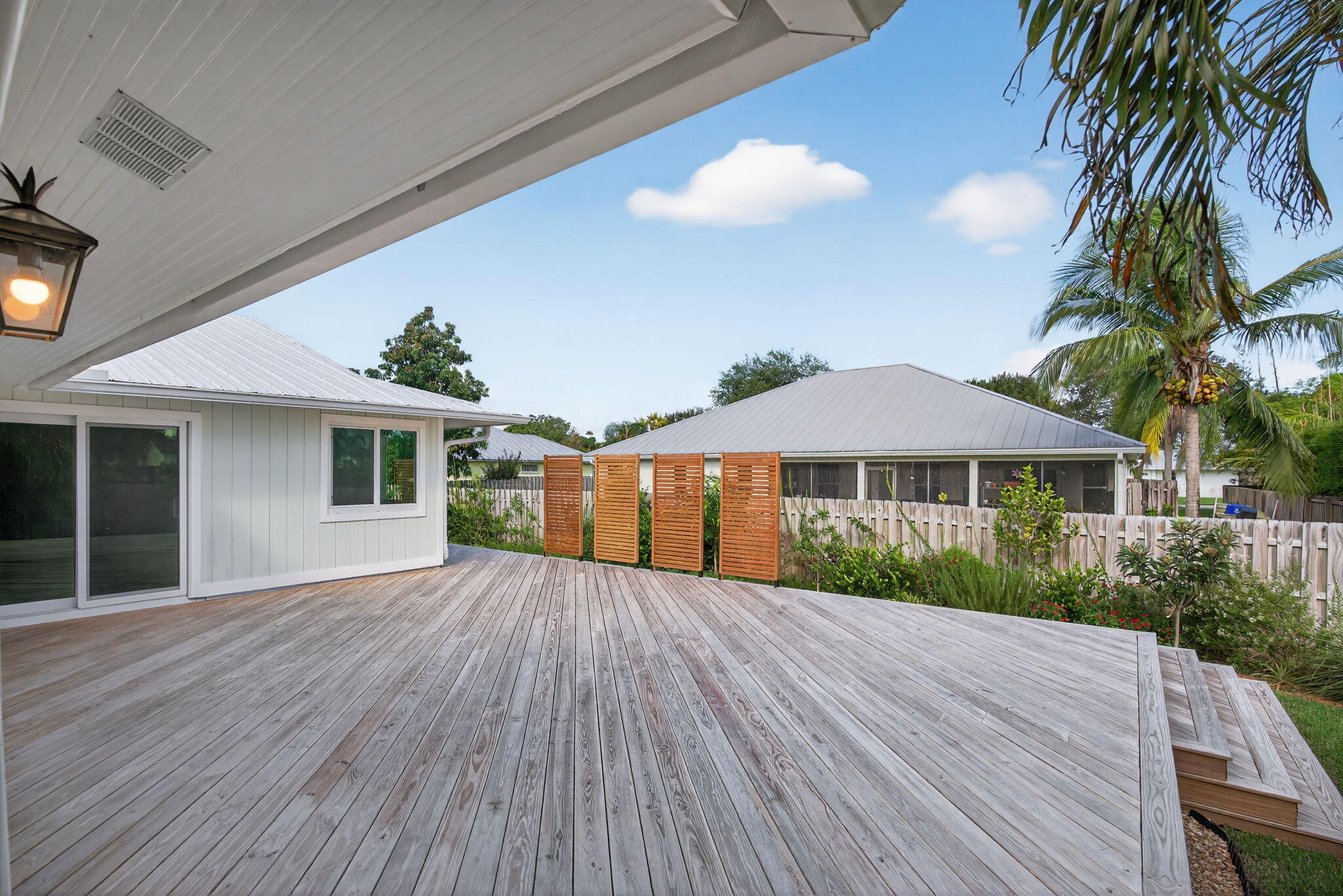 5273 Southeast Tall Pines Way Stuart, FL 34997 - Photo 50 of 62 a front view of house with yard and trees