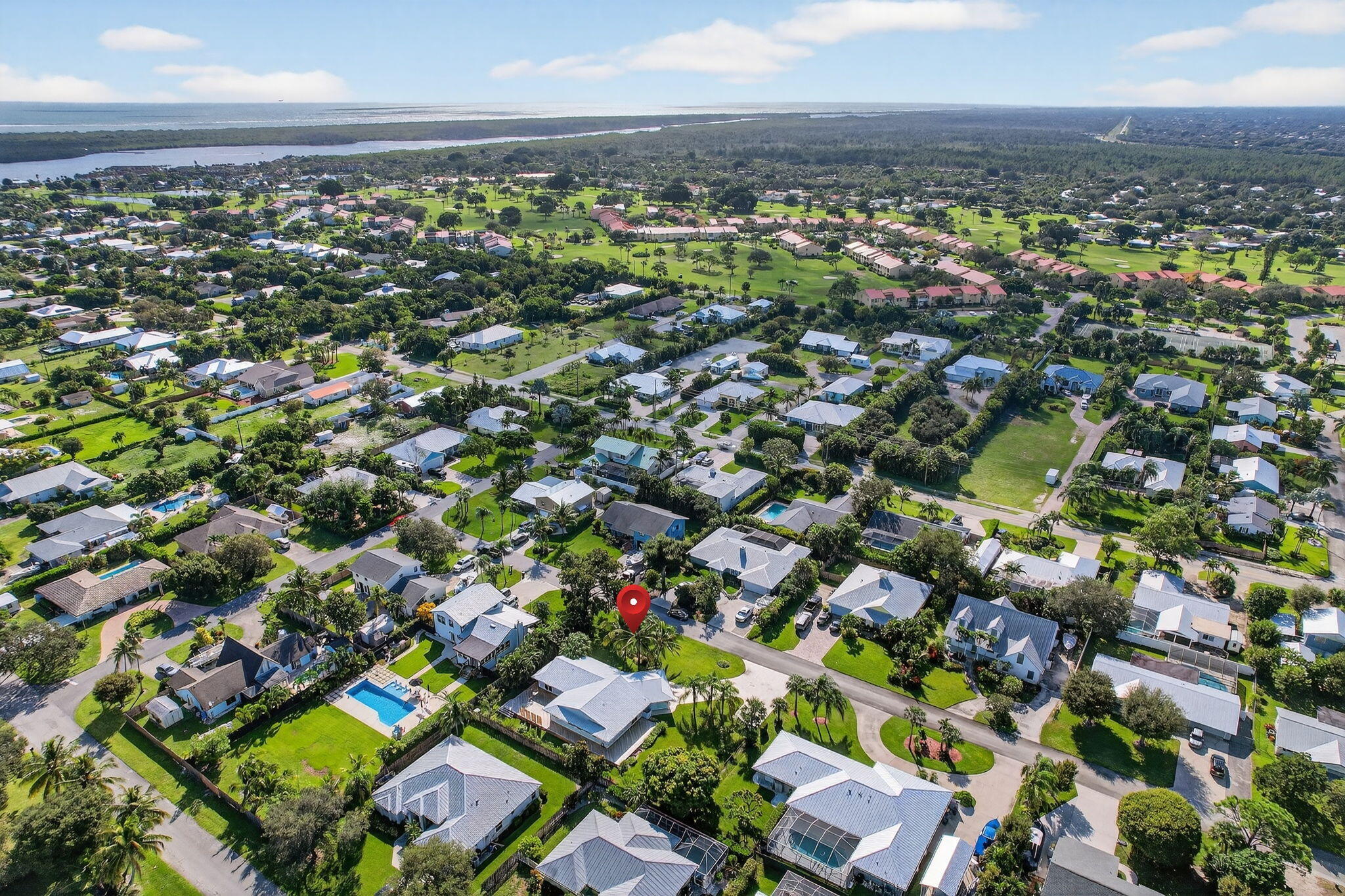 5273 Southeast Tall Pines Way Stuart, FL 34997 - Photo 62 of 62 an aerial view of residential houses with outdoor space and trees