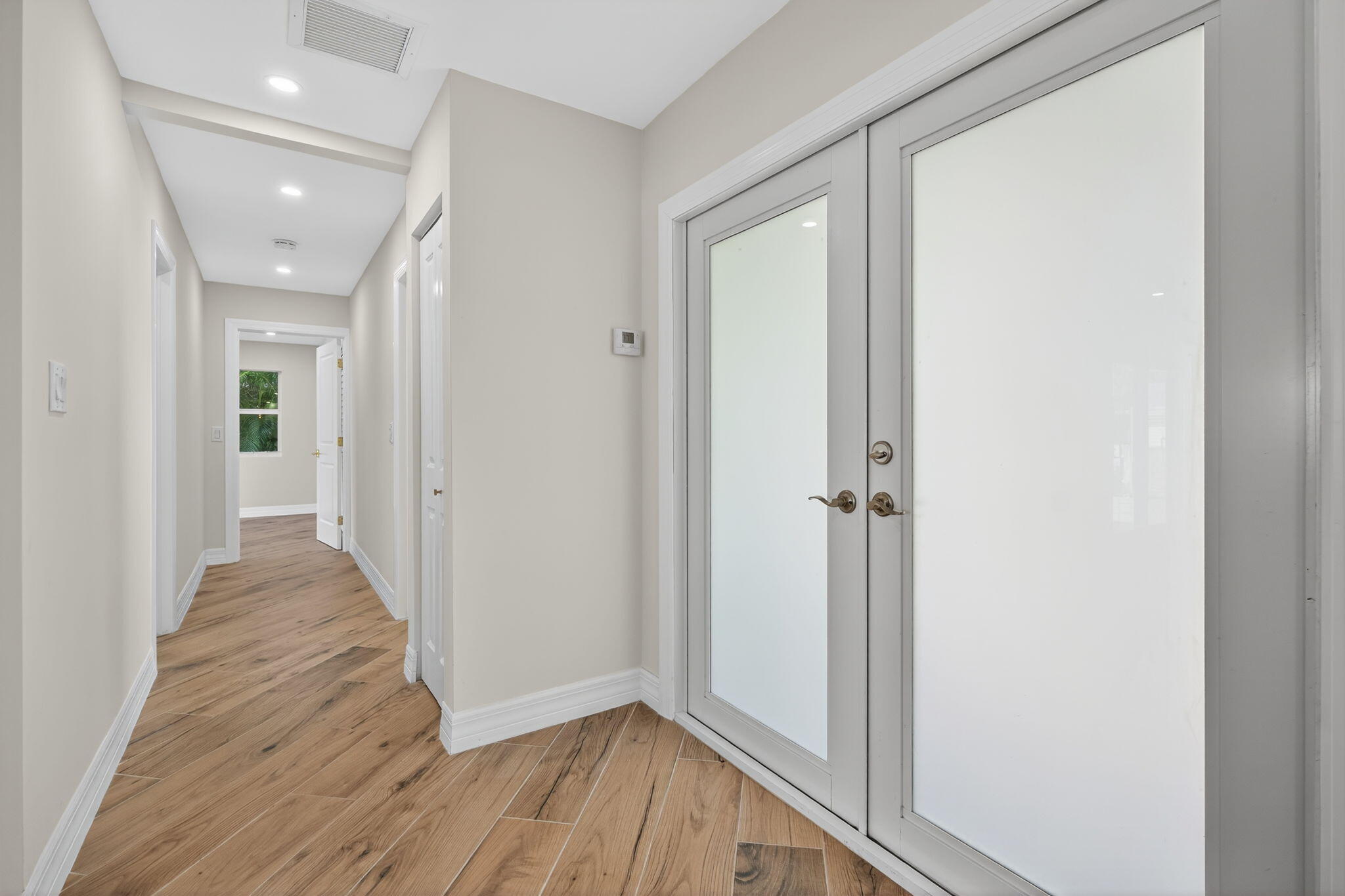5273 Southeast Tall Pines Way Stuart, FL 34997 - Photo 10 of 62 a view of a hallway with wooden floor