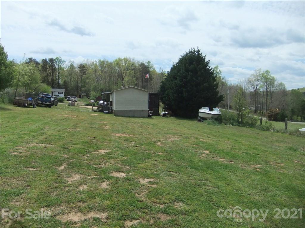553 Parris Road Rutherfordton, NC 28139 - Photo 12 of 23 a view of a green field with trees in the background