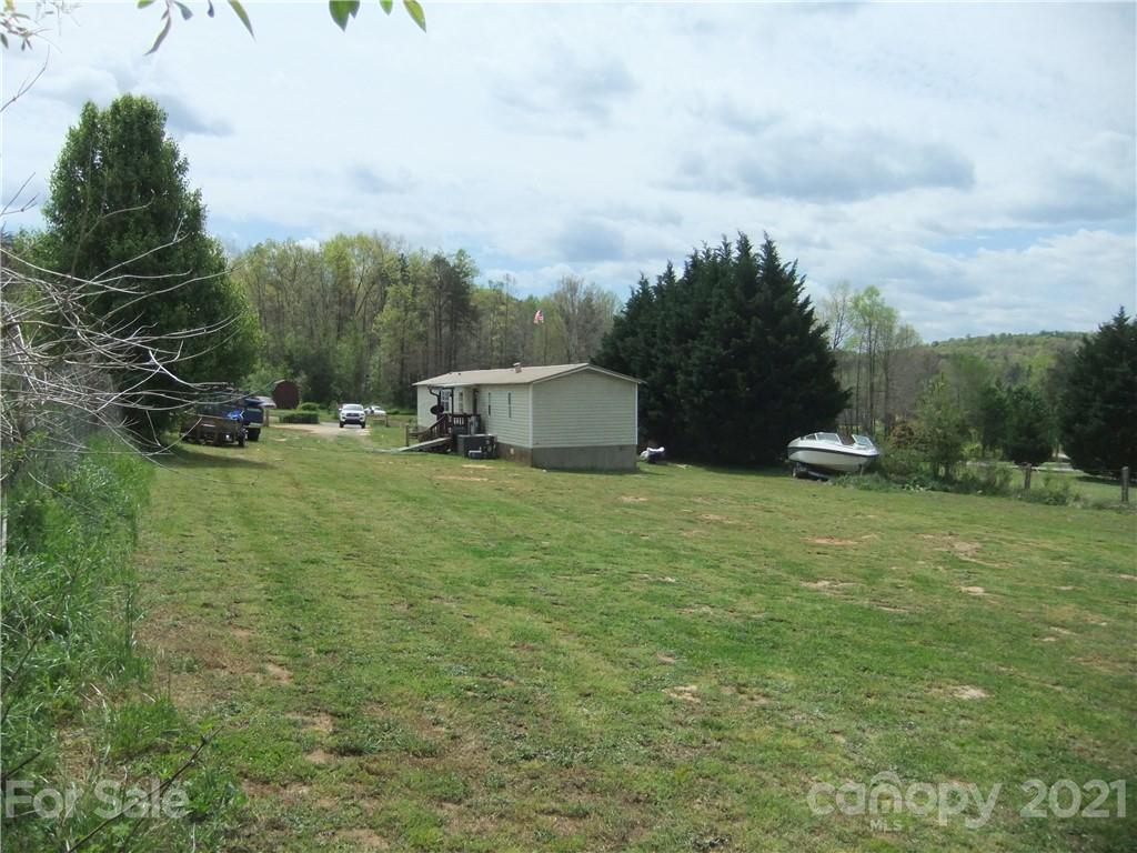553 Parris Road Rutherfordton, NC 28139 - Photo 17 of 23 a backyard of a house with lots of green space and garden