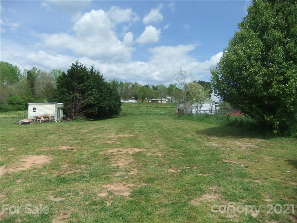 553 Parris Road Rutherfordton, NC 28139 - Photo 18 of 23 a view of a garden with a building in the background