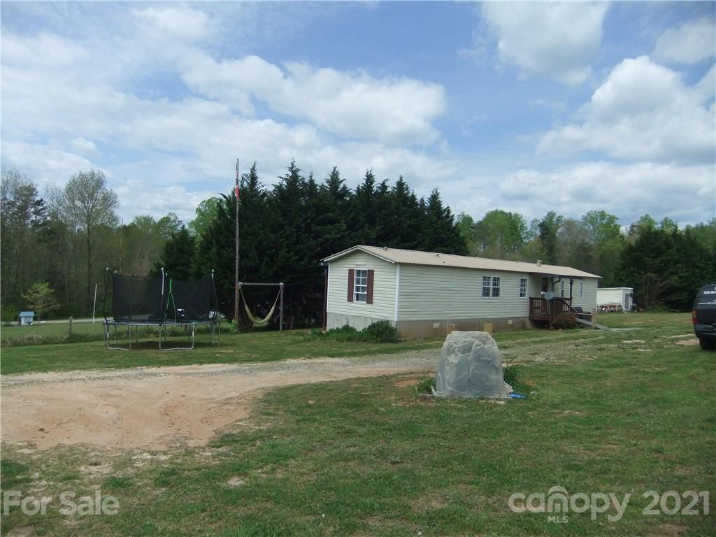 553 Parris Road Rutherfordton, NC 28139 - Photo 22 of 23 a view of a yard in front of a house with large trees