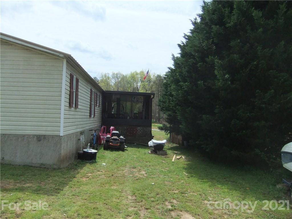553 Parris Road Rutherfordton, NC 28139 - Photo 9 of 23 a backyard of a house with wooden table and chairs