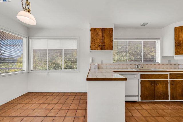 a kitchen with a stove a sink and a counter space