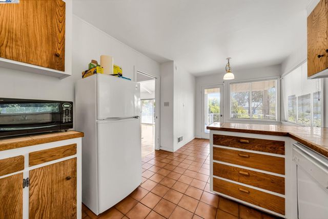 a kitchen with a refrigerator and a stove