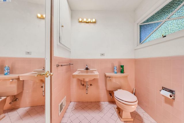 a bathroom with a toilet a sink and a shower