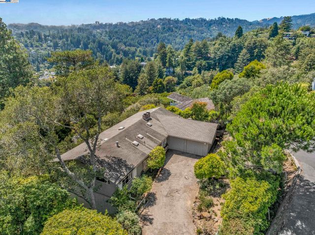an aerial view of a house with mountain view