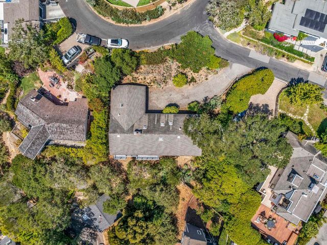 an aerial view of a house with a yard and outdoor seating