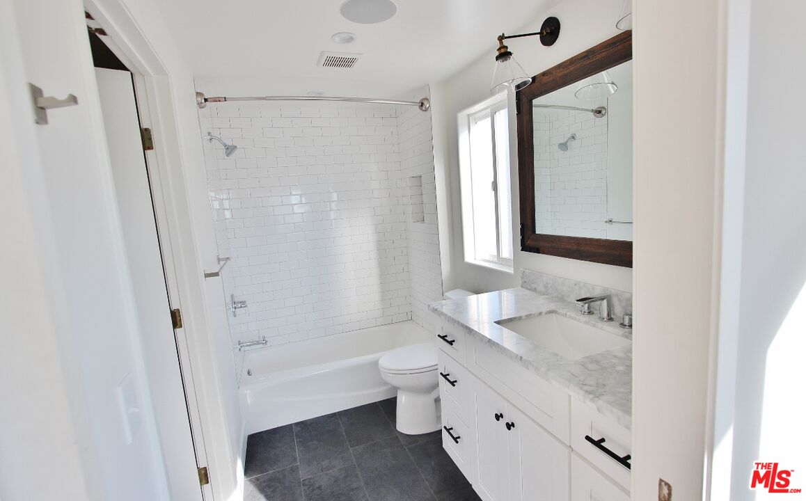19 66th Avenue Playa del Rey, CA 90293 - Photo 15 of 20 a bathroom with a granite countertop sink toilet and shower