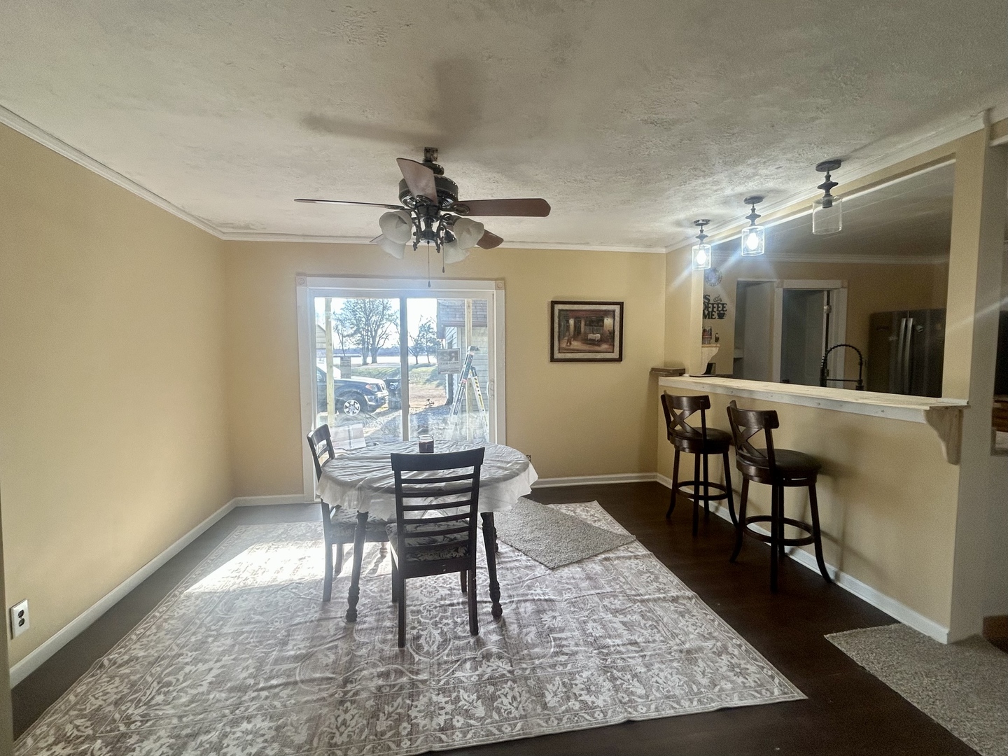 207 Butler Street Metropolis, IL 62960 - Photo 19 of 28 a dining room with wooden floor and chandelier