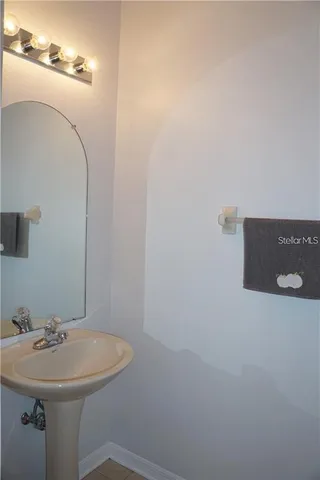 a bathroom with a sink and mirror