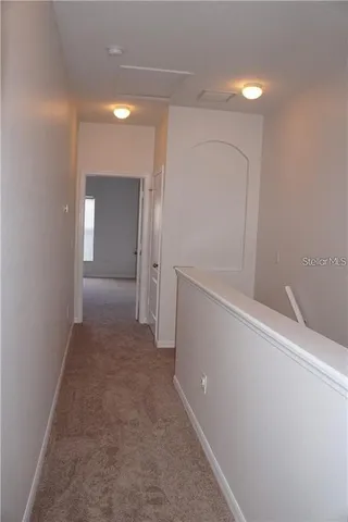 a view of hallway with bathroom