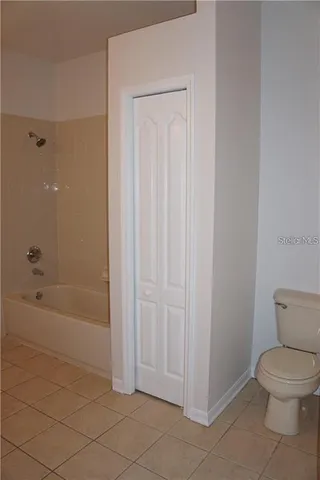 a bathroom with a toilet and a bathtub