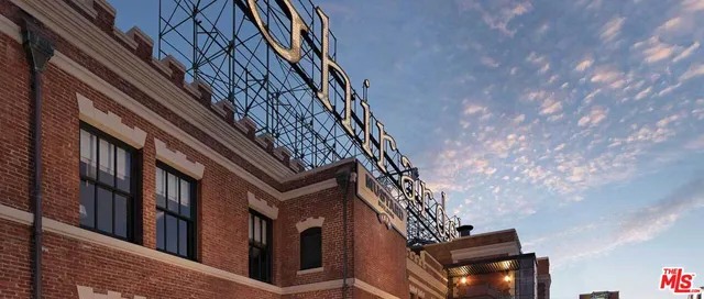 a bedroom with a bed and a flat tv screen on dresser