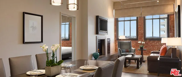 a view of a living room with furniture and wooden floor