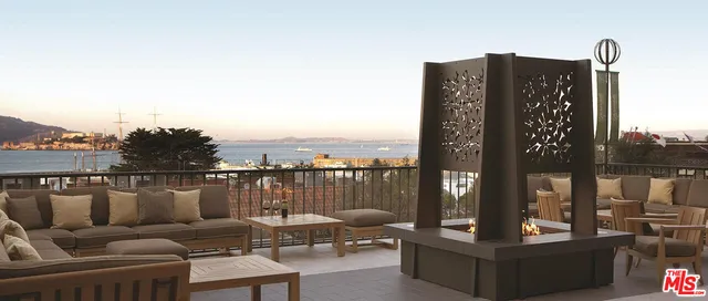 a balcony with table and chairs