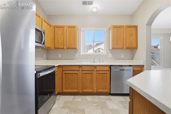 a kitchen that has a sink and a stove