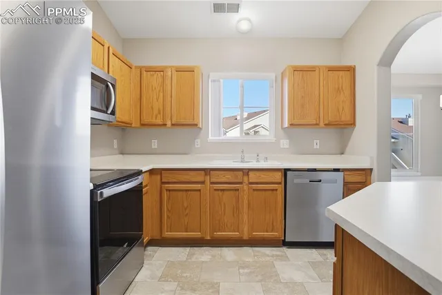 a kitchen that has a sink and a stove